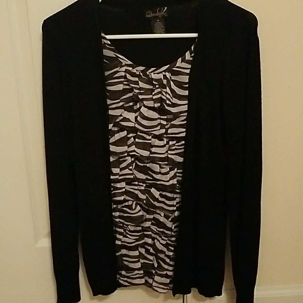black sweater with a belt and purses